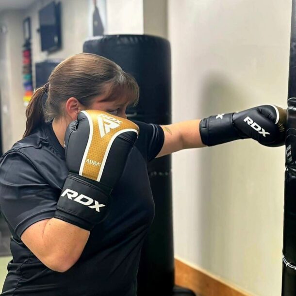 Woman hitting the punchbag in training