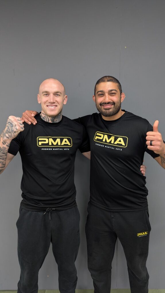 Adult martial arts students posing after a workout