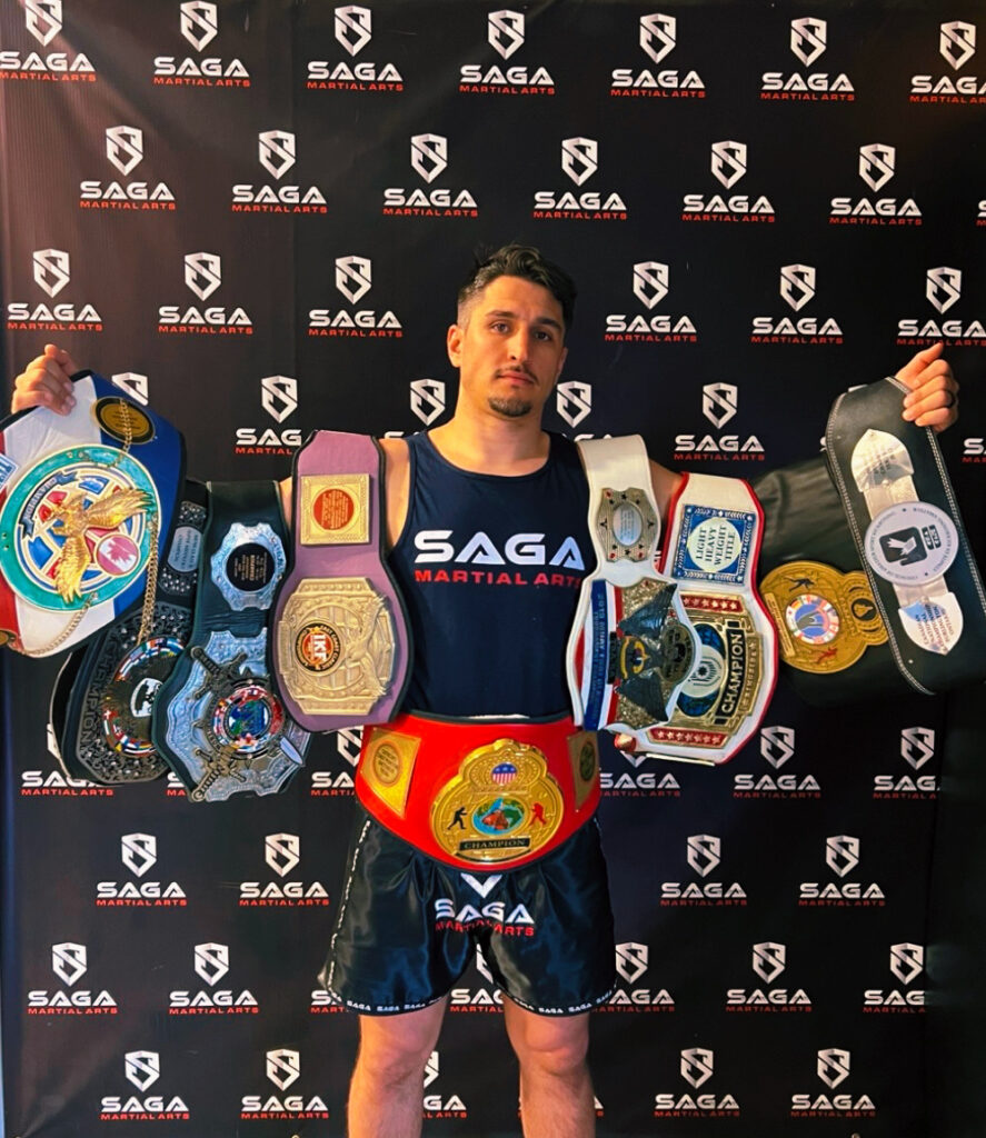 Kru Jake Mackenzie with championship belts