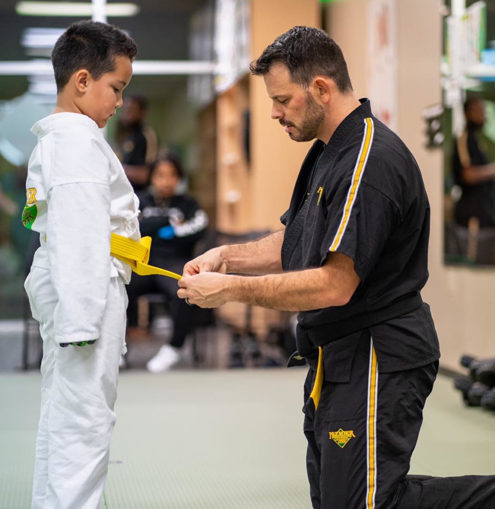 Child being awarded a karate belt