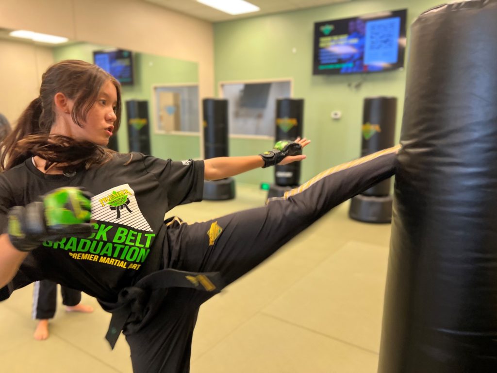 A martial arts student performing a powerful roundhouse kick