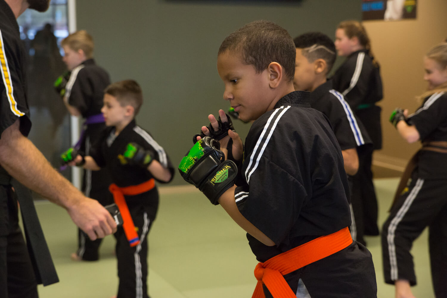 A young martial arts student showing intense focus and confidence